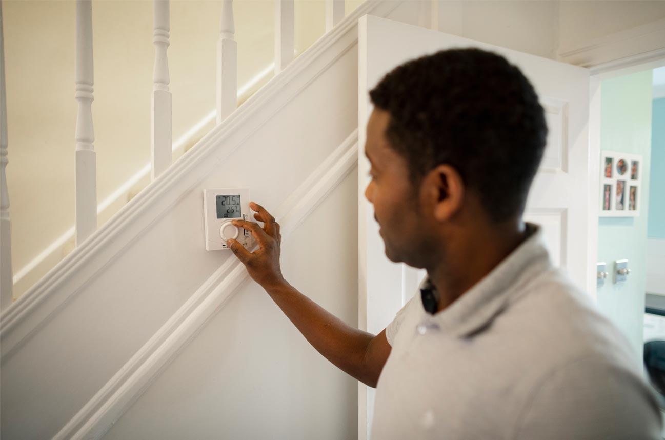 householder adjusting smart thermostat